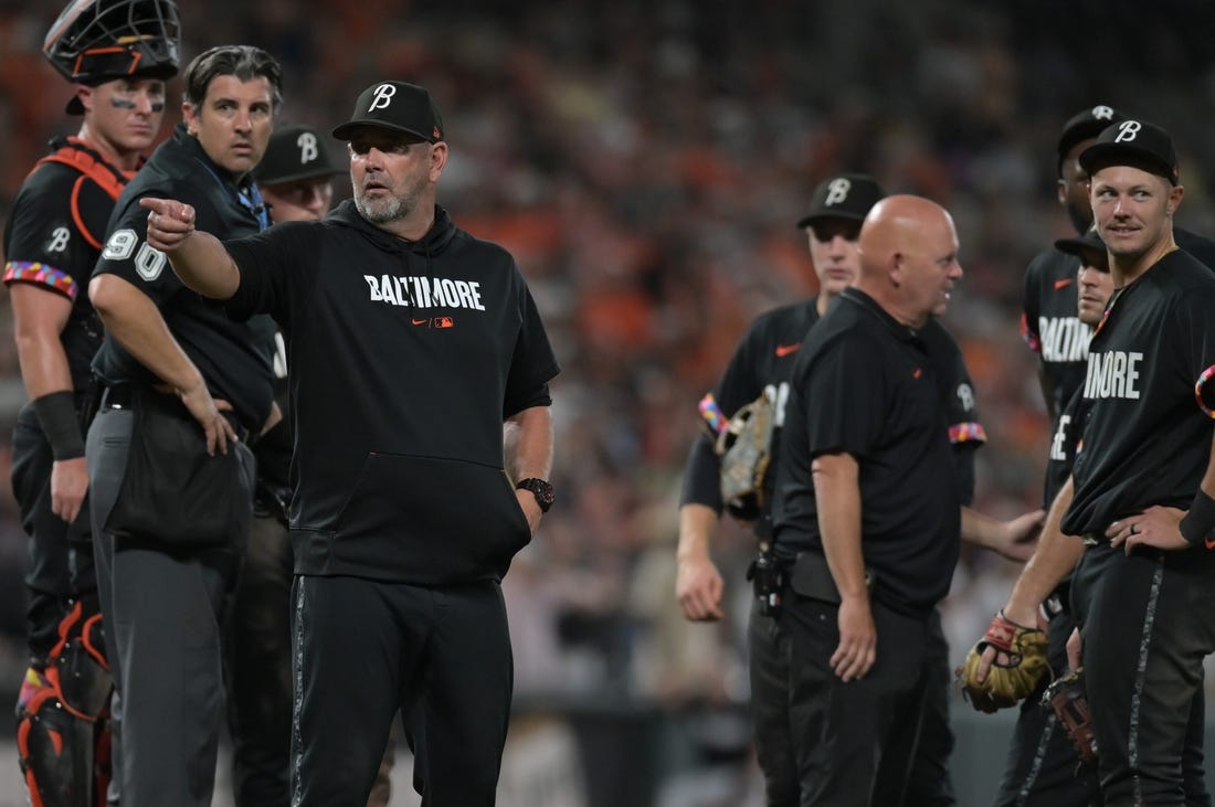 Aug 25, 2023; Baltimore, Maryland, USA;  Baltimore Orioles manager Brandon Hyde (18) signals to the dugout after relief pitcher Felix Bautista (74) slipped on the pitcher's mound during the ninth inning against the Colorado Rockies at Oriole Park at Camden Yards. Mandatory Credit: Tommy Gilligan-USA TODAY Sports