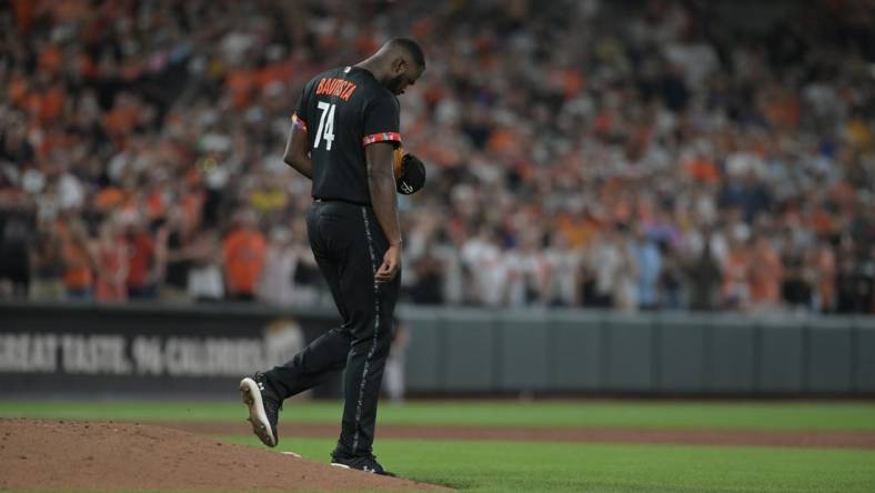 Aug 25, 2023; Baltimore, Maryland, USA;  Baltimore Orioles relief pitcher Felix Bautista (74) walks off the pitcher's mound after slipping while throwing a ninth inning pitch against the Colorado Rockies at Oriole Park at Camden Yards. Mandatory Credit: Tommy Gilligan-USA TODAY Sports