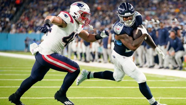 Tennessee Titans running back Julius Chestnut (36)scores a touchdown past New England Patriots linebacker Diego Fagot (42) during the second quarter at Nissan Stadium in Nashville, Tenn., Friday, Aug. 25, 2023.