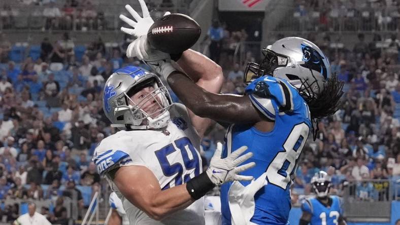 Aug 25, 2023; Charlotte, North Carolina, USA;  Detroit Lions linebacker Trevor Nowaske (59) breaks up a pass in the end zone intended for Carolina Panthers tight end Ian Thomas (80) in the second quarter at Bank of America Stadium. Mandatory Credit: Bob Donnan-USA TODAY Sports