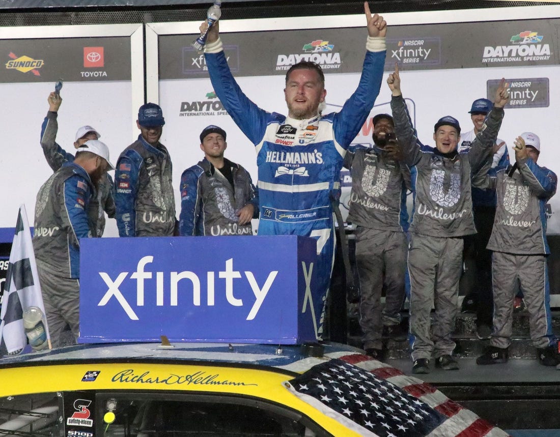 Justin Allgaier stands on his no. 7 Chevrolet in Victory Lane, Friday night August 25, 2023 after winning the Wawa 250 at Daytona International Speedway.