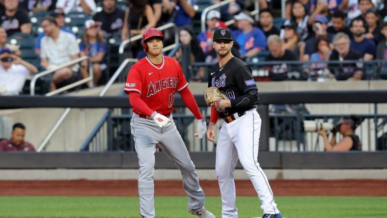 Aug 25, 2023; New York City, New York, USA; Los Angeles Angels designated hitter Shohei Ohtani (17) takes a lead off first base against New York Mets first baseman Pete Alonso (20) after walking during the first inning at Citi Field. Mandatory Credit: Brad Penner-USA TODAY Sports