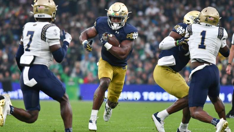 Aug 26, 2023; Dublin, IRL; Notre Dame Fighting Irish running back Audric Estime (7) runs the ball in the first quarter against the Navy Midshipmen at Aviva Stadium. Mandatory Credit: Matt Cashore-USA TODAY Sports