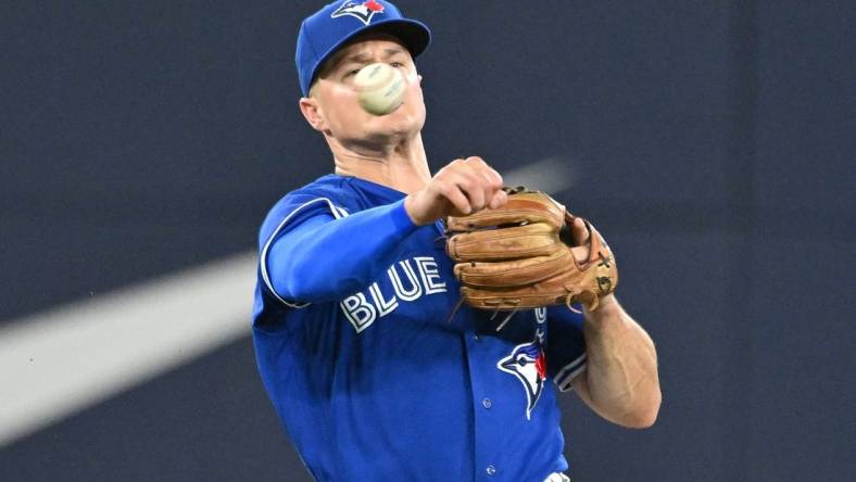 Aug 26, 2023; Toronto, Ontario, CAN;  Toronto Blue Jays third baseman Matt Chapman (26) throws to retire Cleveland Guardians left fielder Oscar Gonzalez (not shown) in the fourth inning at Rogers Centre. Mandatory Credit: Dan Hamilton-USA TODAY Sports