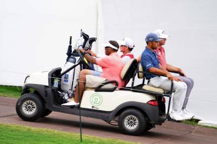 Aug 26, 2023; Atlanta, Georgia, USA; Xander Schauffele and Sam Burns are carted off the course after the horn was blown for a weather delay during the third round of the TOUR Championship golf tournament at East Lake Golf Club. Mandatory Credit: John David Mercer-USA TODAY Sports