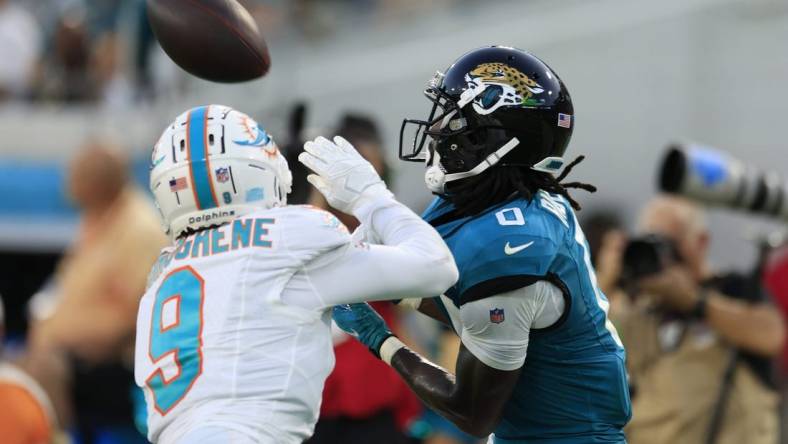 Jacksonville Jaguars wide receiver Calvin Ridley (0) hauls in a reception against Miami Dolphins cornerback Noah Igbinoghene (9) during the second quarter of a preseason matchup Saturday, Aug. 26, 2023 at EverBank Stadium in Jacksonville, Fla. [Corey Perrine/Florida Times-Union]