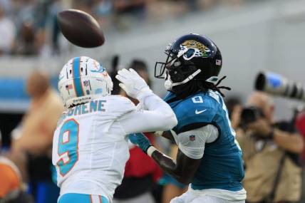 Jacksonville Jaguars wide receiver Calvin Ridley (0) hauls in a reception against Miami Dolphins cornerback Noah Igbinoghene (9) during the second quarter of a preseason matchup Saturday, Aug. 26, 2023 at EverBank Stadium in Jacksonville, Fla. [Corey Perrine/Florida Times-Union]