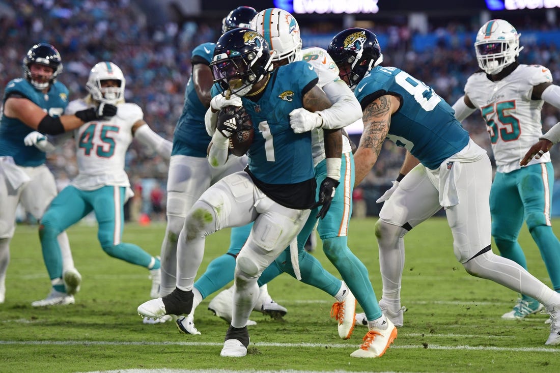 Jacksonville Jaguars running back D'Ernest Johnson (25) runs into the end  zone to score a touchdown during the first half of an NFL preseason  football game against the Miami Dolphins, Saturday, Aug.