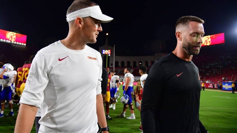 Aug 26, 2023; Los Angeles, California, USA; Southern California Trojans head coach Lincoln Riley speaks with assistant coach Kliff Kingsbury following the victory against the San Jose State Spartans at Los Angeles Memorial Coliseum. Mandatory Credit: Gary A. Vasquez-USA TODAY Sports