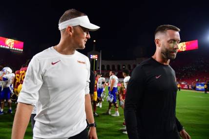 Aug 26, 2023; Los Angeles, California, USA; Southern California Trojans head coach Lincoln Riley speaks with assistant coach Kliff Kingsbury following the victory against the San Jose State Spartans at Los Angeles Memorial Coliseum. Mandatory Credit: Gary A. Vasquez-USA TODAY Sports