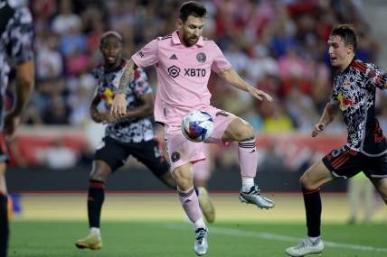 Aug 26, 2023; Harrison, New Jersey, USA; Inter Miami CF forward Lionel Messi (10) controls the ball against New York Red Bulls defender Andres Reyes (4) and midfielder Peter Stroud (5) during the second half at Red Bull Arena. Mandatory Credit: Brad Penner-USA TODAY Sports
