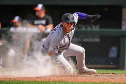 Aug 27, 2023; Baltimore, Maryland, USA; Colorado Rockies first baseman Hunter Goodman (15) scores a run during the ninth inning against the Baltimore Orioles at Oriole Park at Camden Yards. Mandatory Credit: Reggie Hildred-USA TODAY Sports