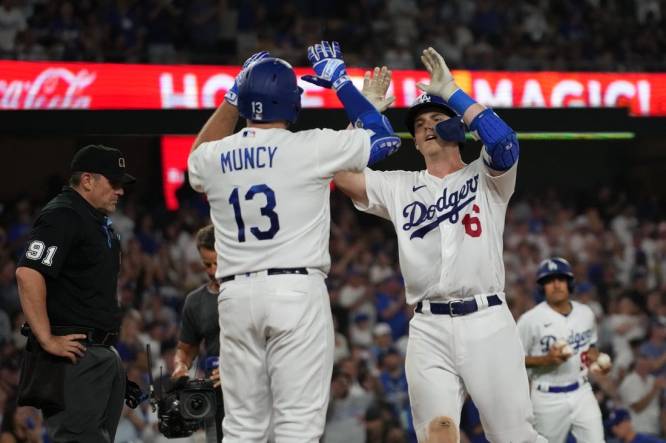 Aug 29, 2023; Los Angeles, California, USA; Los Angeles Dodgers catcher Will Smith (16) celebrates with third baseman Max Muncy (13) after hitting a home run in the sixth inning against the Arizona Diamondbacks at Dodger Stadium. Mandatory Credit: Kirby Lee-USA TODAY Sports
