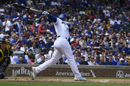 Aug 30, 2023; Chicago, Illinois, USA; Chicago Cubs left fielder Ian Happ (8) hits an RBI double against the Milwaukee Brewers during the first inning at Wrigley Field. Mandatory Credit: Matt Marton-USA TODAY Sports