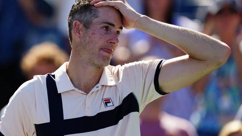 Aug 31, 2023; Flushing, NY, USA;  John Isner of the United States reacts as he is interviewed after losing his second round match against Michael Mmoh of the United States on day four of the 2023 U.S. Open tennis tournament at the USTA Billie Jean King National Tennis Center. Mandatory Credit: Jerry Lai-USA TODAY Sports