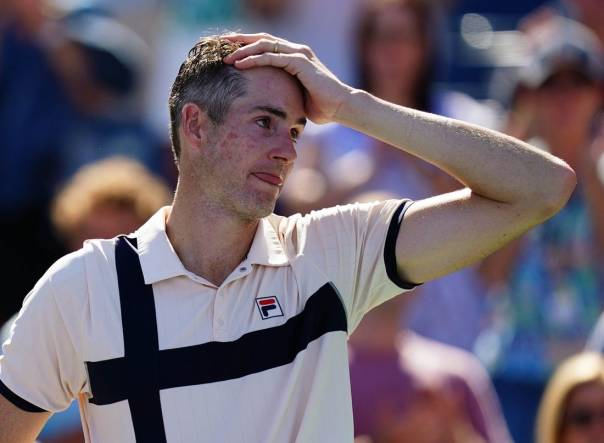 Aug 31, 2023; Flushing, NY, USA;  John Isner of the United States reacts as he is interviewed after losing his second round match against Michael Mmoh of the United States on day four of the 2023 U.S. Open tennis tournament at the USTA Billie Jean King National Tennis Center. Mandatory Credit: Jerry Lai-USA TODAY Sports
