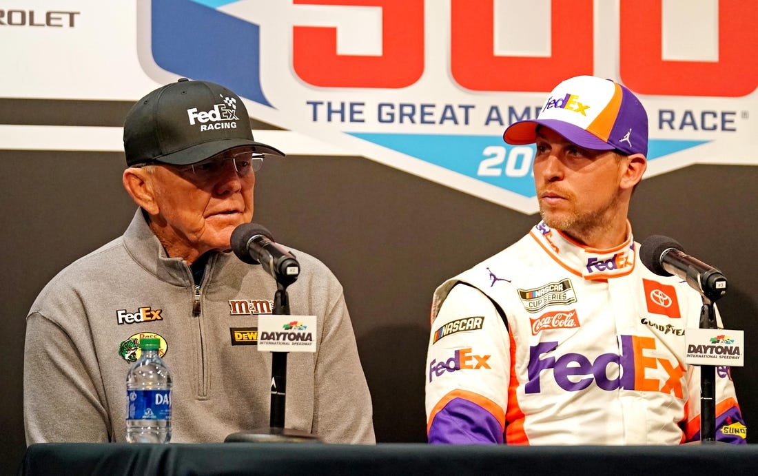 Feb 17, 2020; Daytona Beach, Florida, USA; NASCAR Cup Series driver Denny Hamlin (11) speaks to media with team owner Joe Gibbs (left) after the Daytona 500 at Daytona International Speedway. Mandatory Credit: John David Mercer-USA TODAY Sports