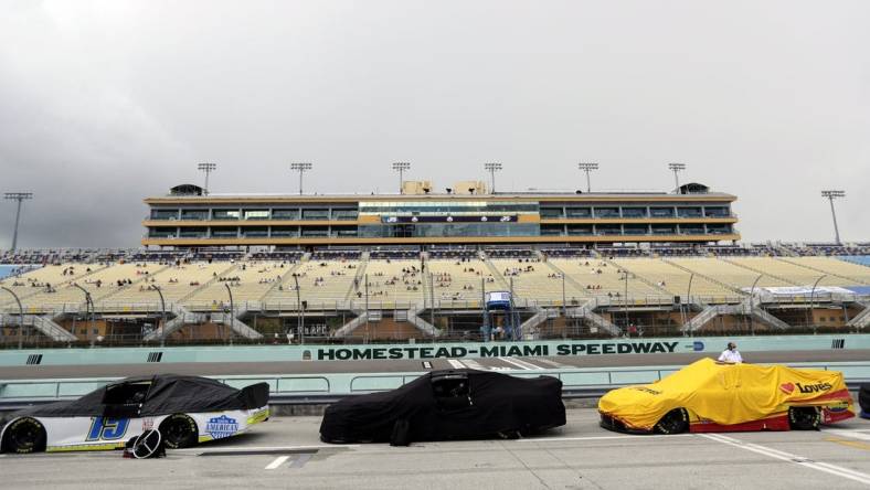 Jun 14, 2020; Homestead, Florida, USA; A general view as cars are covered during a rain delay prior to the NASCAR Cup series race at Homestead-Miami Speedway. Mandatory Credit: Wilfredo Lee/Pool Photo via USA TODAY Network