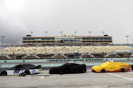 Jun 14, 2020; Homestead, Florida, USA; A general view as cars are covered during a rain delay prior to the NASCAR Cup series race at Homestead-Miami Speedway. Mandatory Credit: Wilfredo Lee/Pool Photo via USA TODAY Network