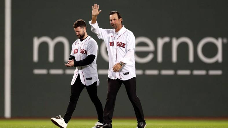 Oct 19, 2021; Boston, Massachusetts, USA; Former Boston Red Sox pitcher Tim Wakefield and singer-songwriter Calum Scott walk onto the field for a ceremonial first pitch before game four of the 2021 ALCS between the Boston Red Sox and the Houston Astros at Fenway Park. Mandatory Credit: Paul Rutherford-USA TODAY Sports