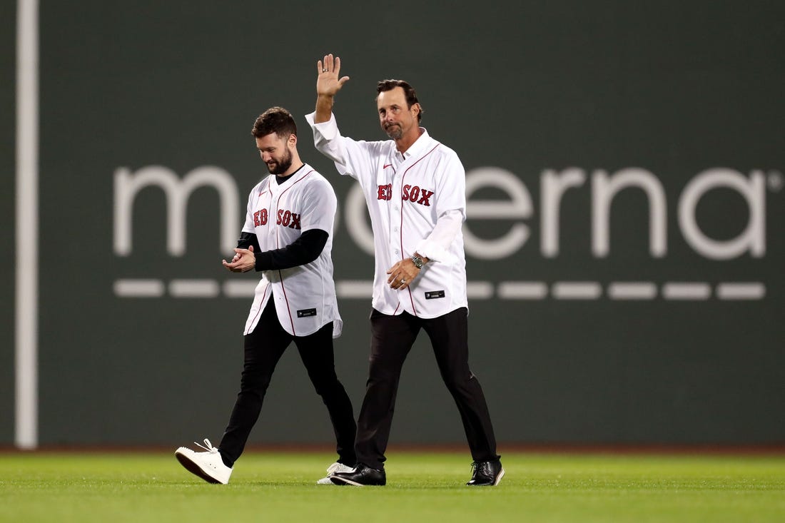Oct 19, 2021; Boston, Massachusetts, USA; Former Boston Red Sox pitcher Tim Wakefield and singer-songwriter Calum Scott walk onto the field for a ceremonial first pitch before game four of the 2021 ALCS between the Boston Red Sox and the Houston Astros at Fenway Park. Mandatory Credit: Paul Rutherford-USA TODAY Sports