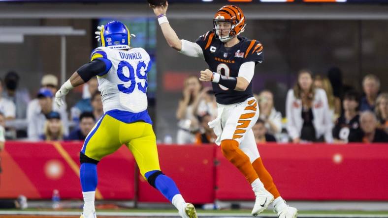 Feb 13, 2022; Inglewood, CA, USA; Cincinnati Bengals quarterback Joe Burrow (9) throws a pass against Los Angeles Rams defensive end Aaron Donald (99) in the fourth quarter of Super Bowl LVI at SoFi Stadium. Mandatory Credit: Mark J. Rebilas-USA TODAY Sports