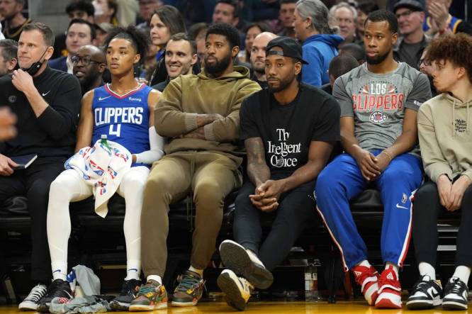 Mar 8, 2022; San Francisco, California, USA; LA Clippers guard Paul George (center, left) and forward Kawhi Leonard (center, right) sit in street clothes on the bench during the second quarter against the Golden State Warriors at Chase Center. Mandatory Credit: Darren Yamashita-USA TODAY Sports