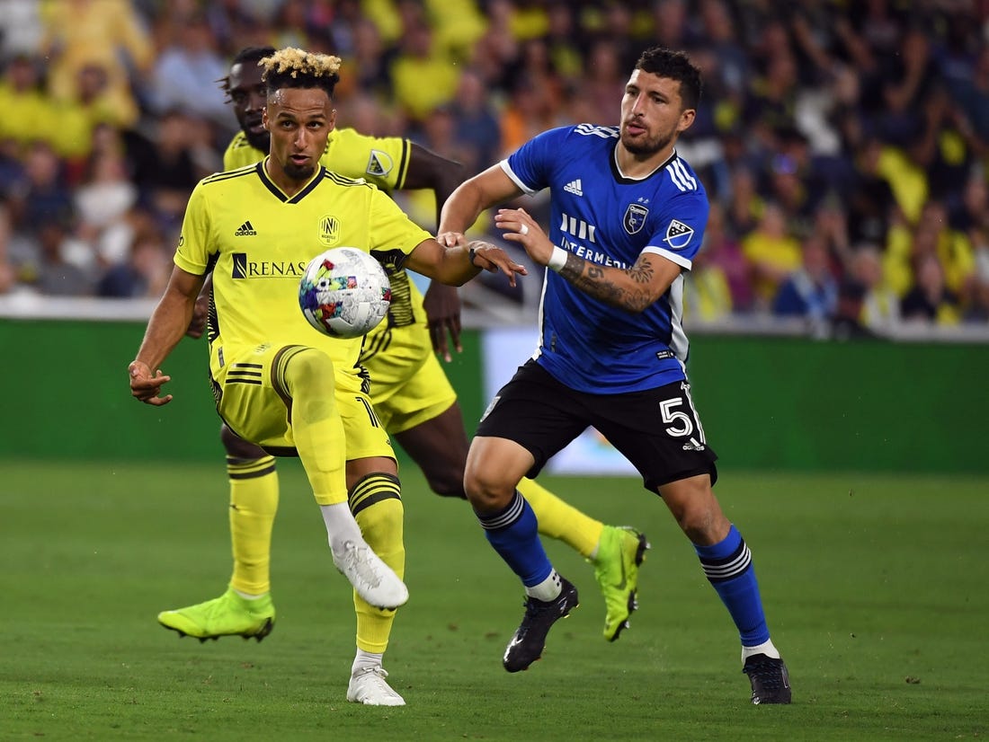 Jun 11, 2022; Nashville, Tennessee, USA; Nashville SC midfielder Hany Mukhtar (10) plays the ball into the box during the second half against the San Jose Earthquakes at Geodis Park. Mandatory Credit: Christopher Hanewinckel-USA TODAY Sports