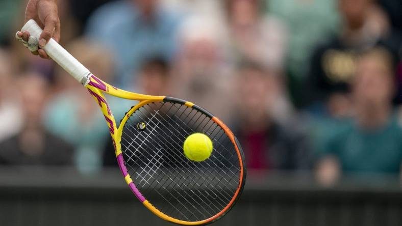 Jun 30, 2022; London, United Kingdom; A detail view of a ball on the racket of Rafael Nadal (ESP) during his match against Ricardas Berankis (LTU) on day four at All England Lawn Tennis and Croquet Club. Mandatory Credit: Susan Mullane-USA TODAY Sports