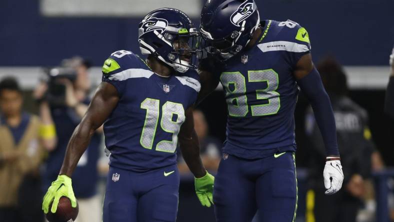 Aug 26, 2022; Arlington, Texas, USA; Seattle Seahawks wide receiver Penny Hart (19) and wide receiver Dareke Young (83) celebrate a touchdown in first quarter against the Dallas Cowboys at AT&T Stadium. Mandatory Credit: Tim Heitman-USA TODAY Sports