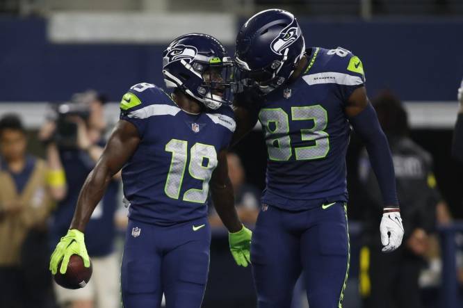 Aug 26, 2022; Arlington, Texas, USA; Seattle Seahawks wide receiver Penny Hart (19) and wide receiver Dareke Young (83) celebrate a touchdown in first quarter against the Dallas Cowboys at AT&T Stadium. Mandatory Credit: Tim Heitman-USA TODAY Sports