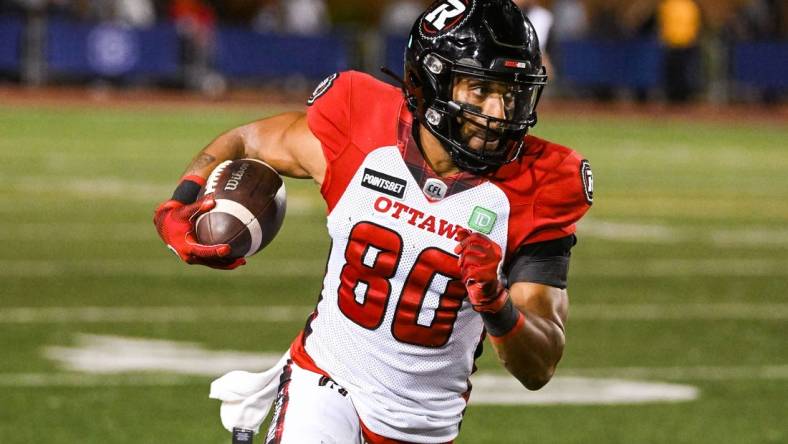 Sep 2, 2022; Montreal, Quebec, CAN; Ottawa Redblacks wide receiver Nate Behar (80) runs the ball against the Montreal Alouettes during the fourth quarter at Percival Molson Memorial Stadium. Mandatory Credit: David Kirouac-USA TODAY Sports