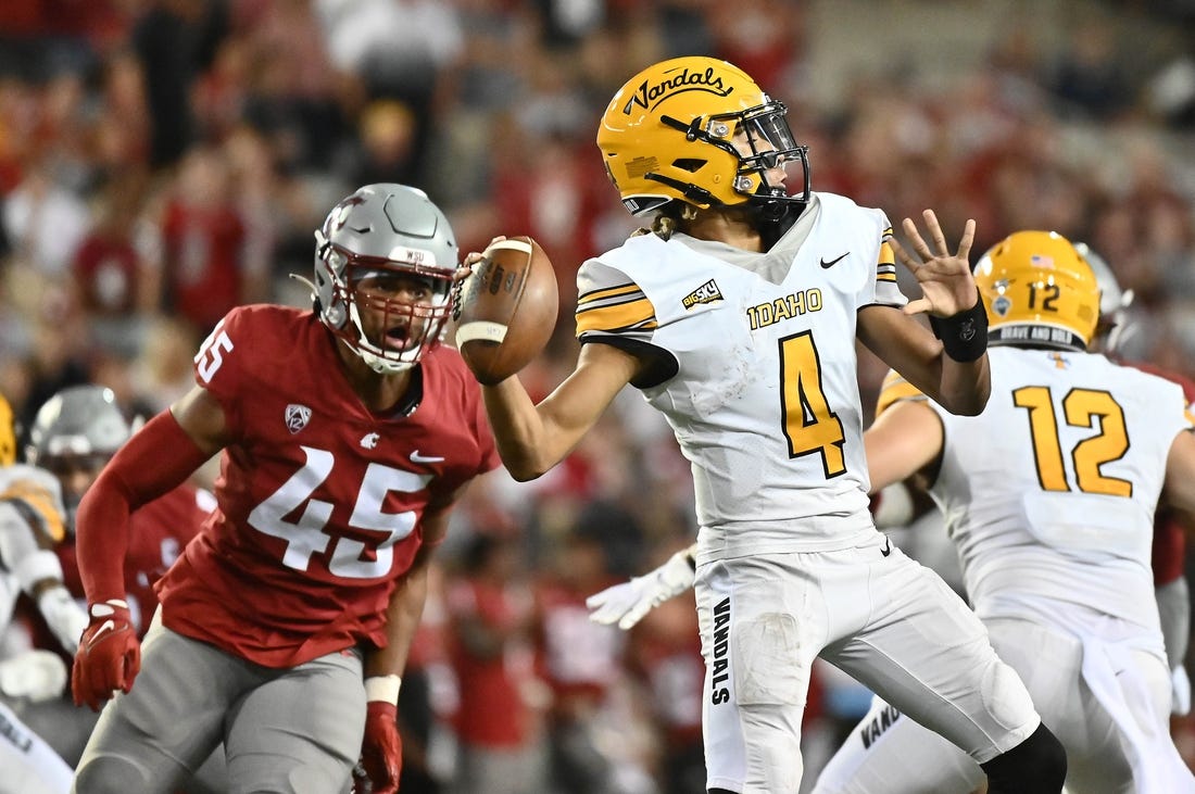 Sep 3, 2022; Pullman, Washington, USA; Idaho Vandals quarterback Gevani McCoy (4) throws the ball against Washington State Cougars defensive end Raam Stevenson (45) in the second half at Gesa Field at Martin Stadium. Mandatory Credit: James Snook-USA TODAY Sports