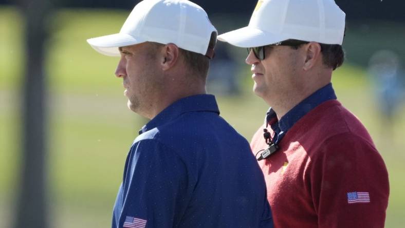 Team USA golfer Justin Thomas (left) and assistant captain Zach Johnson (right) talk on the 13th green during the foursomes match play of the Presidents Cup golf tournament at Quail Hollow Club (file photo). Mandatory Credit: Jim Dedmon-USA TODAY Sports