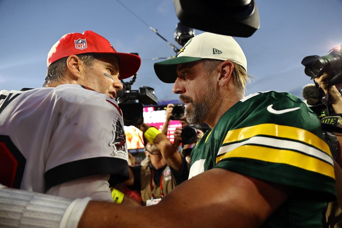 Sep 25, 2022; Tampa, Florida, USA; Tampa Bay Buccaneers quarterback Tom Brady (12) and Green Bay Packers quarterback Aaron Rodgers (12) greet after the game at Raymond James Stadium. Mandatory Credit: Kim Klement-USA TODAY Sports