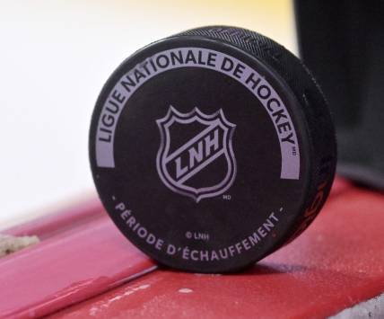 Oct 4, 2022; Montreal, Quebec, CAN; A puck with the NHL logo during the warmup period before the game between the Ottawa Senators and the Montreal Canadiens at the Bell Centre. Mandatory Credit: Eric Bolte-USA TODAY Sports