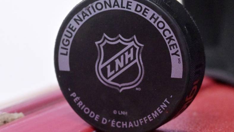 Oct 4, 2022; Montreal, Quebec, CAN; A puck with the NHL logo during the warmup period before the game between the Ottawa Senators and the Montreal Canadiens at the Bell Centre. Mandatory Credit: Eric Bolte-USA TODAY Sports