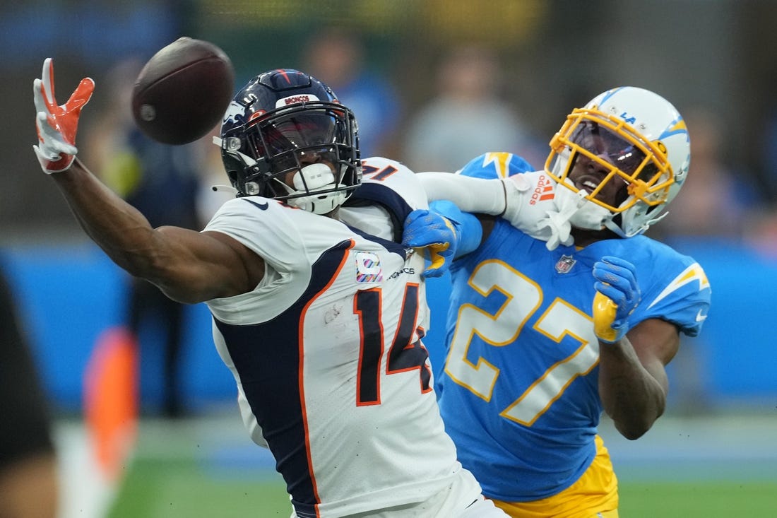 Oct 17, 2022; Inglewood, California, USA; Denver Broncos wide receiver Courtland Sutton (14) attempts to catch the ball as Los Angeles Chargers cornerback J.C. Jackson (27) defends in the first quarter at SoFi Stadium. Mandatory Credit: Kirby Lee-USA TODAY Sports