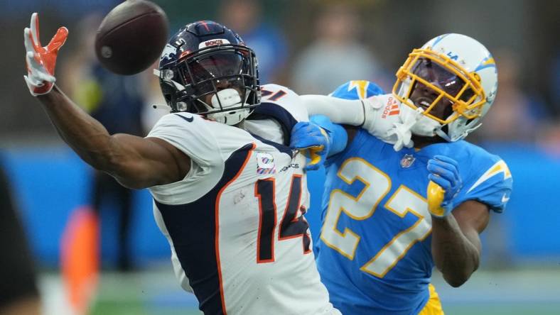 Oct 17, 2022; Inglewood, California, USA; Denver Broncos wide receiver Courtland Sutton (14) attempts to catch the ball as Los Angeles Chargers cornerback J.C. Jackson (27) defends in the first quarter at SoFi Stadium. Mandatory Credit: Kirby Lee-USA TODAY Sports