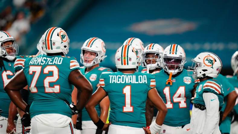 Oct 23, 2022; Miami Gardens, Florida, USA; Miami Dolphins offensive tackle Terron Armstead (72) and Miami Dolphins quarterback Tua Tagovailoa (1) talk to teammates prior to a game against the Pittsburgh Steelers at Hard Rock Stadium. Mandatory Credit: Rich Storry-USA TODAY Sports