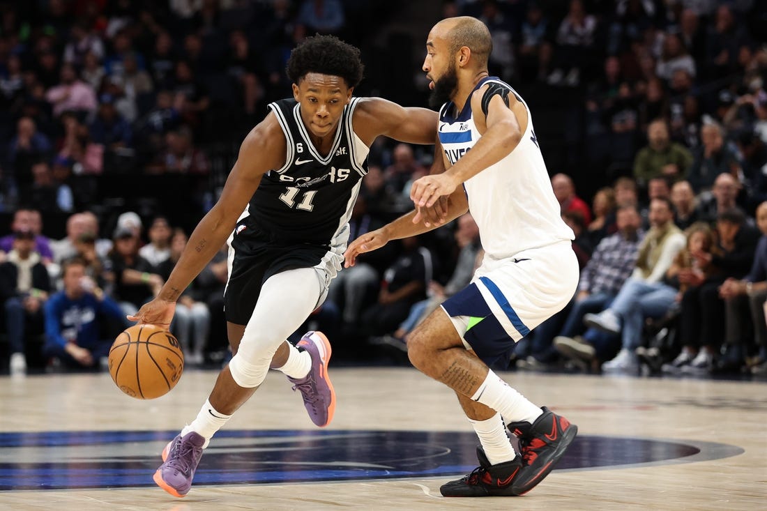 Oct 24, 2022; Minneapolis, Minnesota, USA; San Antonio Spurs guard Joshua Primo (11) dribbles while Minnesota Timberwolves guard Jordan McLaughlin (6) defends during the first quarter at Target Center. Mandatory Credit: Matt Krohn-USA TODAY Sports