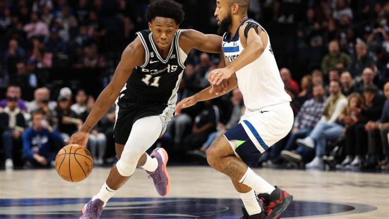 Oct 24, 2022; Minneapolis, Minnesota, USA; San Antonio Spurs guard Joshua Primo (11) dribbles while Minnesota Timberwolves guard Jordan McLaughlin (6) defends during the first quarter at Target Center. Mandatory Credit: Matt Krohn-USA TODAY Sports