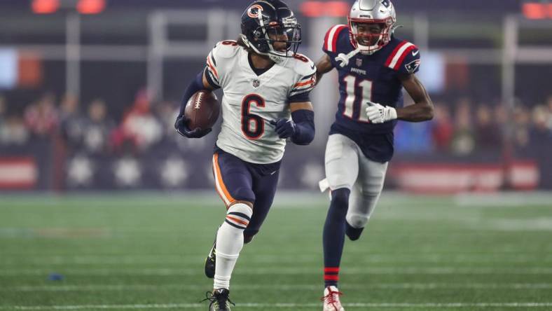 Oct 24, 2022; Foxborough, Massachusetts, USA; Chicago Bears cornerback Kyler Gordon (6) runs the ball after an interception during the second half against the New England Patriots at Gillette Stadium. Mandatory Credit: Paul Rutherford-USA TODAY Sports
