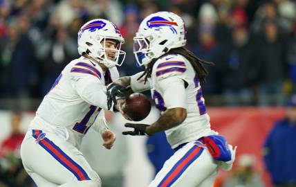 Dec 1, 2022; Foxborough, Massachusetts, USA; Buffalo Bills quarterback Josh Allen (17) hands off the ball to running back James Cook (28) against the New England Patriots in the first quarter at Gillette Stadium. Mandatory Credit: David Butler II-USA TODAY Sports
