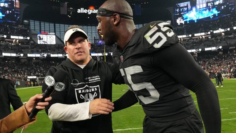 Dec 18, 2022; Paradise, Nevada, USA; Las Vegas Raiders coach Josh McDaniels (left) and defensive end Chandler Jones (55) embrace at the end of the game against the New England Patriots at Allegiant Stadium. The Raiders defeated the Patriots 30-24. Mandatory Credit: Kirby Lee-USA TODAY Sports