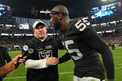 Dec 18, 2022; Paradise, Nevada, USA; Las Vegas Raiders coach Josh McDaniels (left) and defensive end Chandler Jones (55) embrace at the end of the game against the New England Patriots at Allegiant Stadium. The Raiders defeated the Patriots 30-24. Mandatory Credit: Kirby Lee-USA TODAY Sports