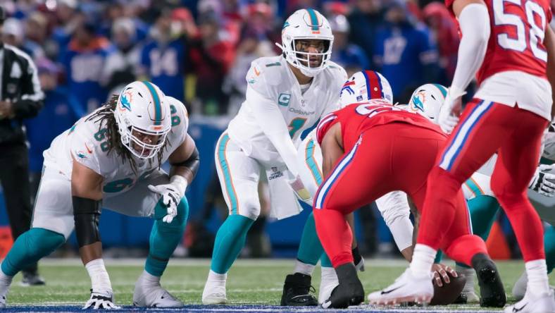 The Miami Dolphins and quarterback Tua Tagovailoa (1) take on the Buffalo Bills in a key AFC East matchup on Sunday. Mandatory Credit: Mark Konezny-USA TODAY Sports