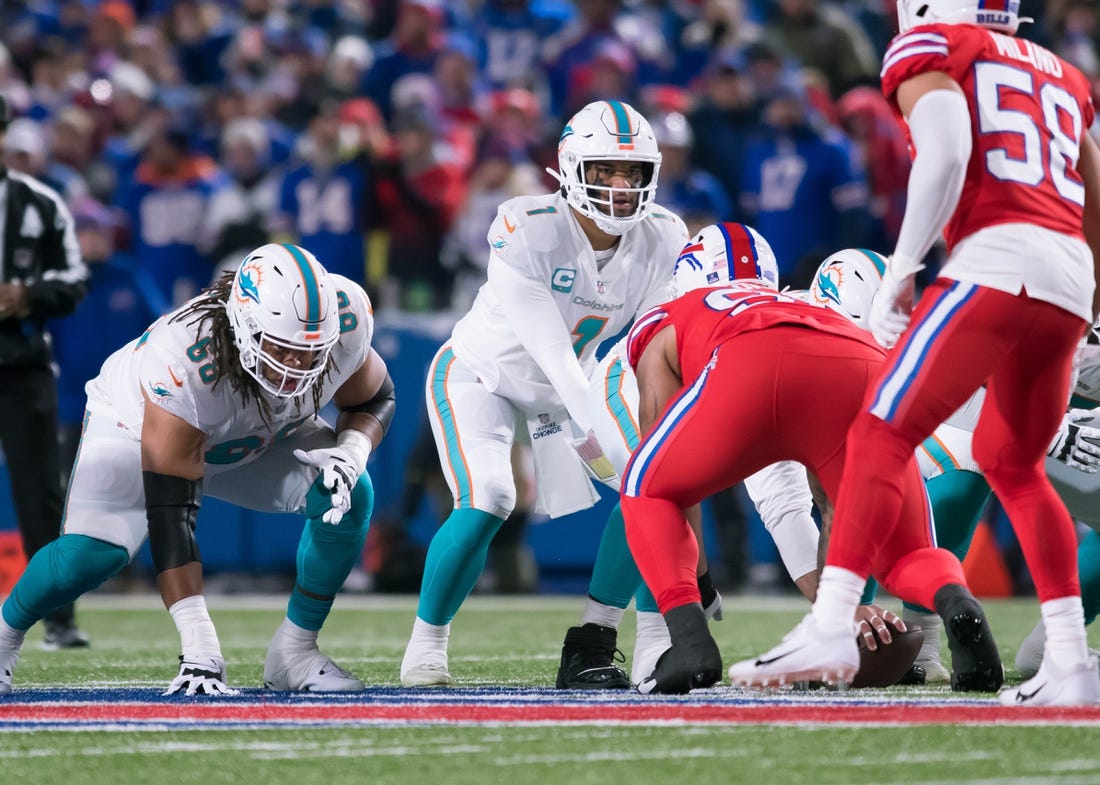 The Miami Dolphins and quarterback Tua Tagovailoa (1) take on the Buffalo Bills in a key AFC East matchup on Sunday. Mandatory Credit: Mark Konezny-USA TODAY Sports