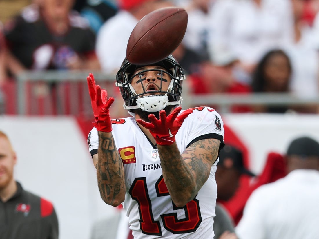 Jan 1, 2023; Tampa, Florida, USA;  Tampa Bay Buccaneers wide receiver Mike Evans (13) catches a pass from touchdown against the Carolina Panthers in the second quarter at Raymond James Stadium. Mandatory Credit: Nathan Ray Seebeck-USA TODAY Sports