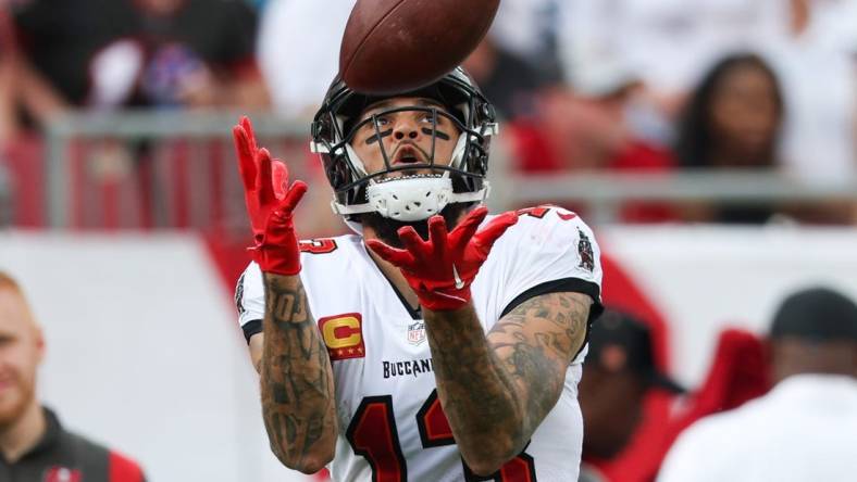 Jan 1, 2023; Tampa, Florida, USA;  Tampa Bay Buccaneers wide receiver Mike Evans (13) catches a pass from touchdown against the Carolina Panthers in the second quarter at Raymond James Stadium. Mandatory Credit: Nathan Ray Seebeck-USA TODAY Sports